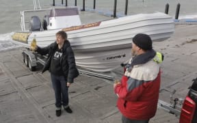 Daughter Bridget Mahy and Greenpeace's Logan Petley toast the boat.