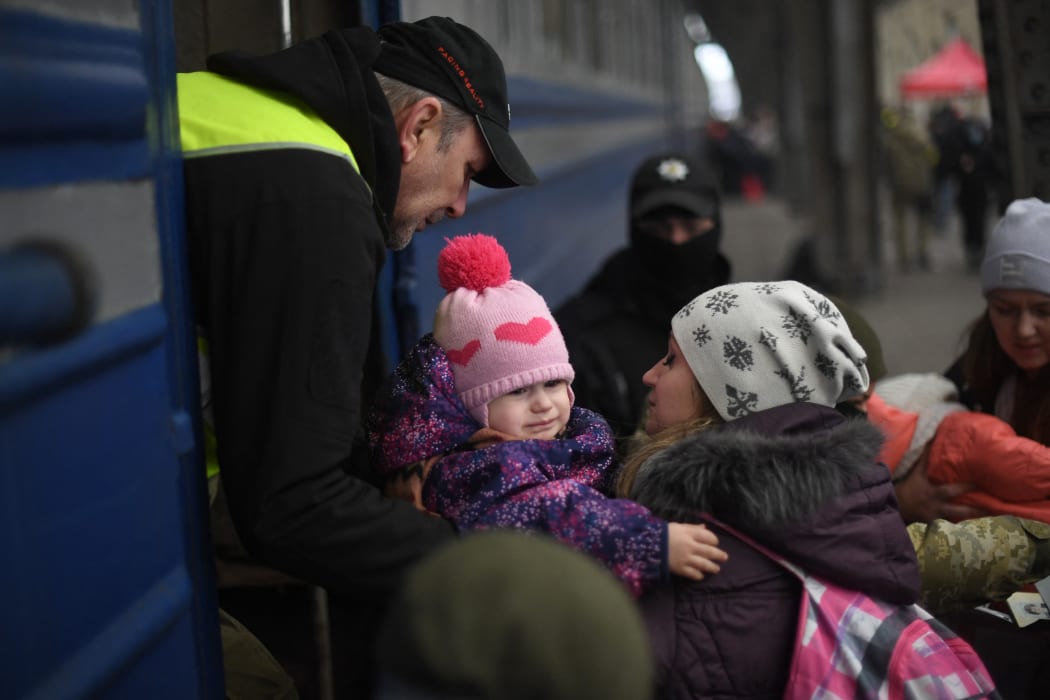 People fleeing Ukraine board a train in Lviv, in the west of the country, en route to Poland, 3 March 2022.