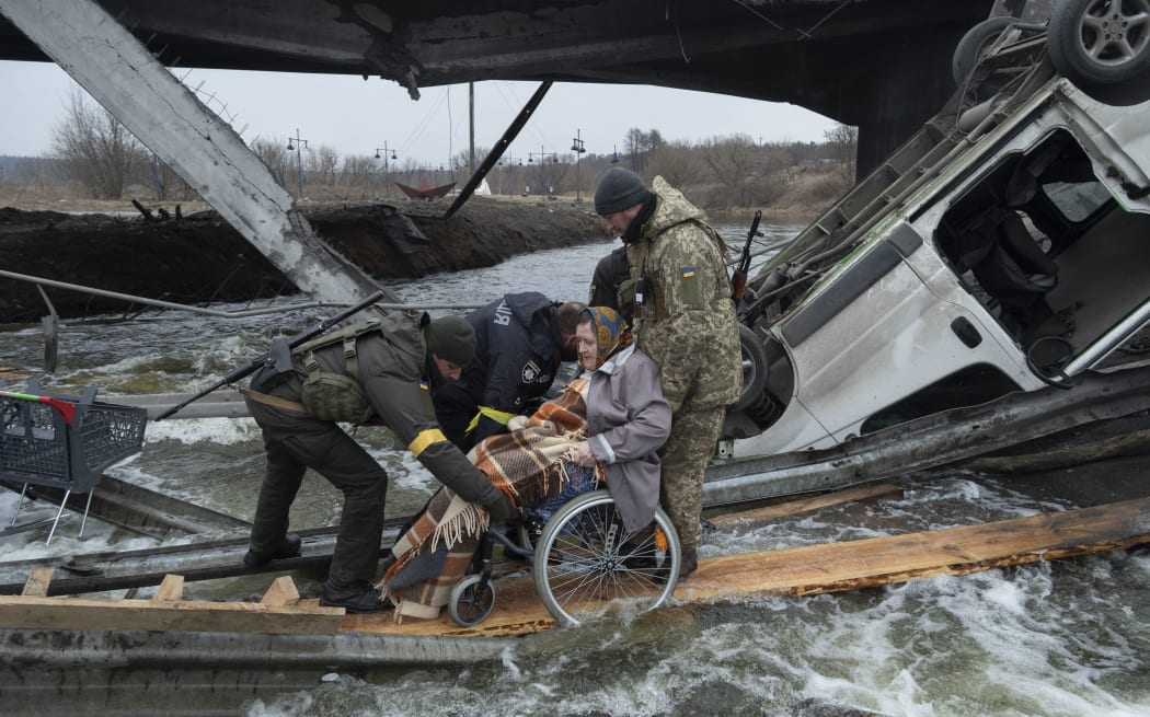 A woman on wheelchair leaves the city of Irpin during the evacuation during the Russia-Ukraine War, on March 7, 2022 (
