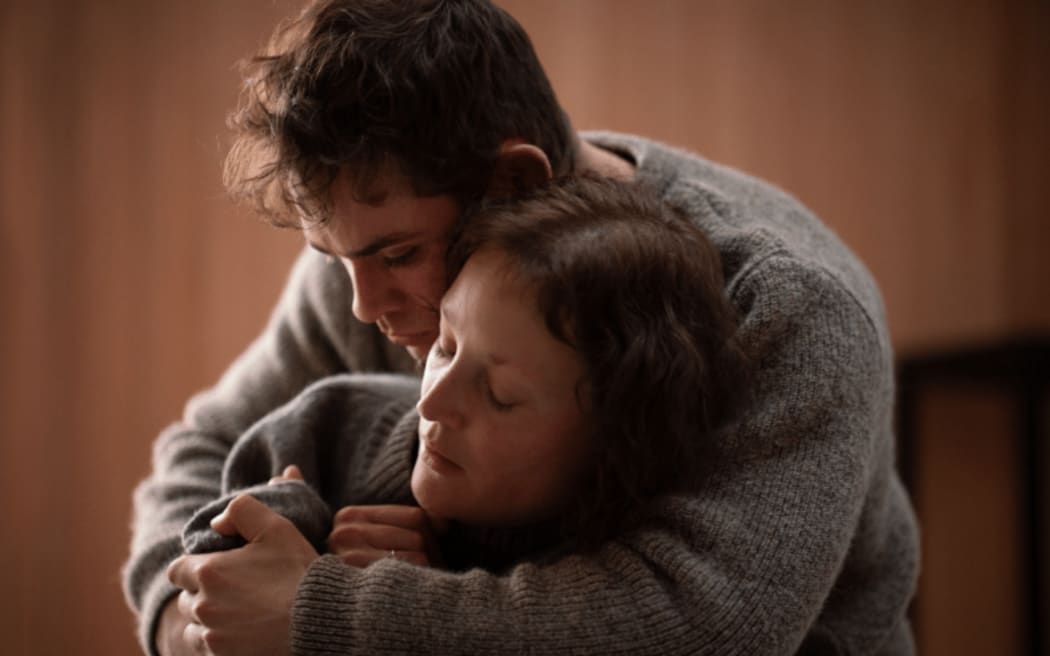 A shot from the film Went Up the Hill of actor Dacre Montgomery holding actress Vicky Krieps.
