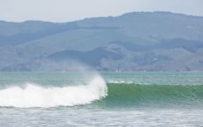 Waves break at a beach.