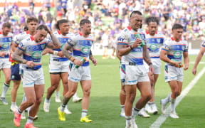 Warriors players leave the field after trailing the Melbourne Storm at hafftime.