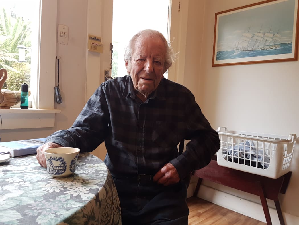 A photo of Baden Norris in his kitchen with a cup of tea