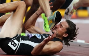 TOKYO, JAPAN - SEPTEMBER 13: Geordie Beamish of Team New Zealand avoids the foot of Jean-Simon Desgagnes of Team Canada as he falls to the ground during the the Men's 3000 Metres Steeplechase Heats on day one of the World Athletics Championships Tokyo 2025 at National Stadium on September 13, 2025 in Tokyo, Japan.  (Photo by Emilee Chinn/Getty Images)