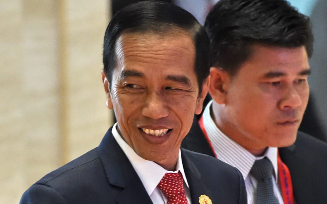 Indonesia's President Joko Widodo (L) arrives at the Association of Southeast Asian Nations (ASEAN) Summit in Vientiane on September 7, 2016.