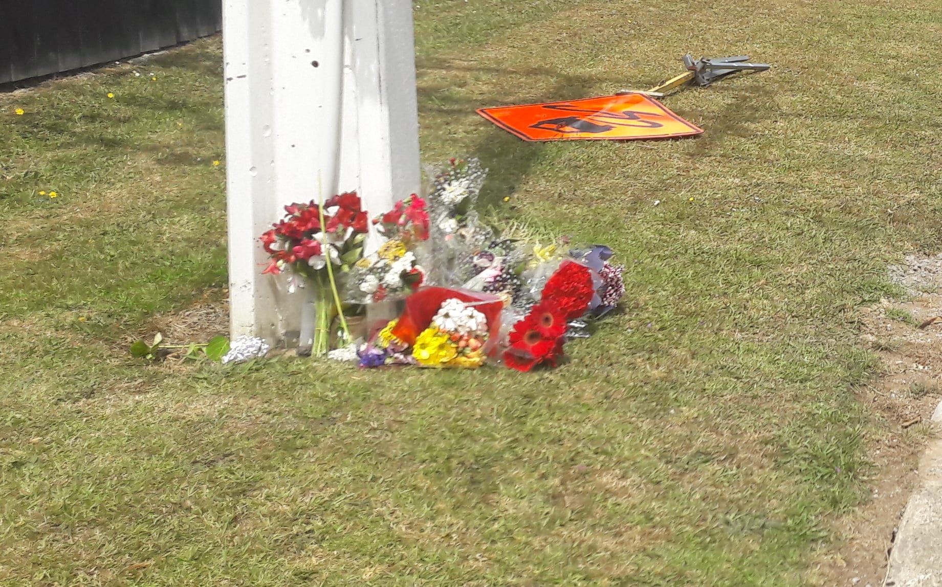 Family members of 16-year-old Jacob Pakura at the road where he was killed.
