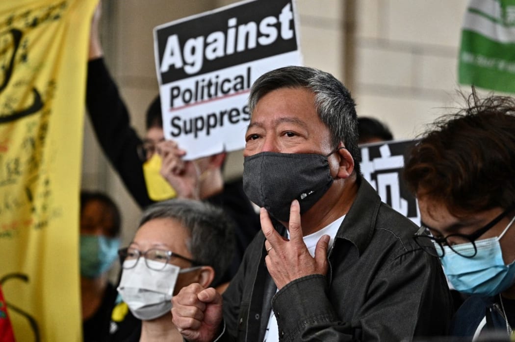 Pro-democracy activist Lee Cheuk-yan (C) arrives at West Kowloon court in Hong Kong on April 16, 2021, to receive sentencing after being found guilty of organising an unauthorised assembly on August 18, 2019.