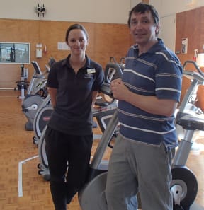 Brighid McCaffrey (left) completed a Masters degree and now works as a clinical exercise physiologist in the Health and Performance Clinic, for which Stacey Reading is Director. Gym equipment includes stationary bikes and weight machines.