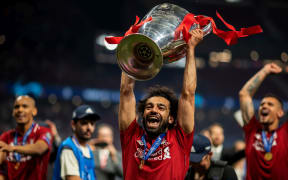 Mohamed Salah of Liverpool celebrates with the UEFA Champions League trophy