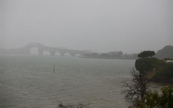 Auckland Harbour Bridge and Waitematā Harbour, seen through heavy rain during a storm, from Wairangi Wharf in Herne Bay, on 4 April, 2025.