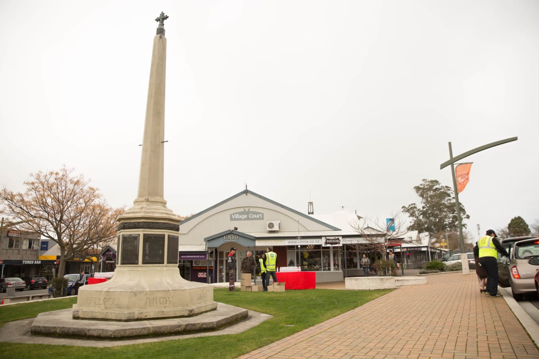 Voluteers in Havelock North town square handing out free bottled water.