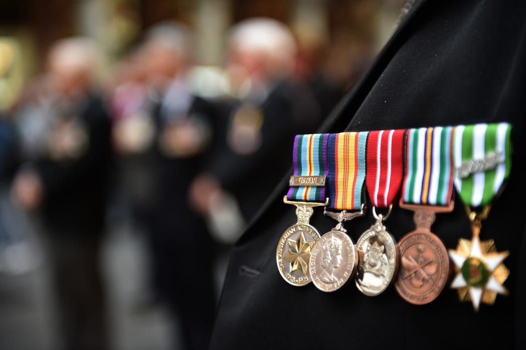 An Australian war veteran wears his medals, including a service medal from the Vietnam war (far left), at the 50th anniversary of the Vietnam Veterans Memorial Service in Sydney.