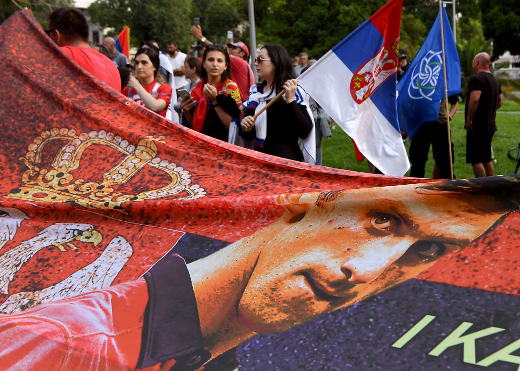 Members of the local Serbian community protest outside a government detention centre where Serbia's tennis champion Novak Djokovic is staying in Melbourne, after he was dramatically refused official entry to Australia over his Covid-19 vaccine status.