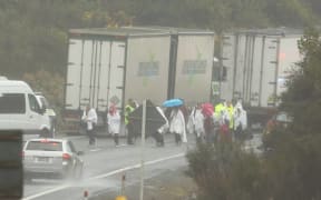 Survivors from the bus crash are led away from the scene.