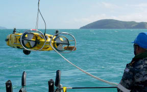 A handout photo taken on July 30, 2023 and received on August 3 from Australian Defence shows Royal Australian Navy sailors from HMAS Huon conducting search operations in the vicinity of Lindeman Island, Queensland. Human remains have been found at the site where an Australian military helicopter plunged into the sea off the country's northeast coast, authorities said on August 3. (Photo by Casey Buurveld / AUSTRALIAN DEFENCE / AFP) / RESTRICTED TO EDITORIAL USE - MANDATORY CREDIT "AFP PHOTO / AUSTRALIAN DEFENCE" - NO MARKETING NO ADVERTISING CAMPAIGNS - DISTRIBUTED AS A SERVICE TO CLIENTS