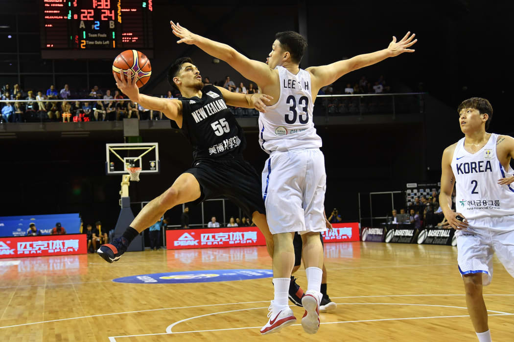 Tall Blacks Shea Ili jumps to shoot with Korea's Seounghyun Lee during the Basketball World Cup qualifier match.