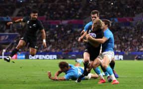 Damian McKenzie of New Zealand scores his team's first try whilst being tackled by Santiago Arata of Uruguay (Photo by Michael Steele - World Rugby/World Rugby via Getty Images)