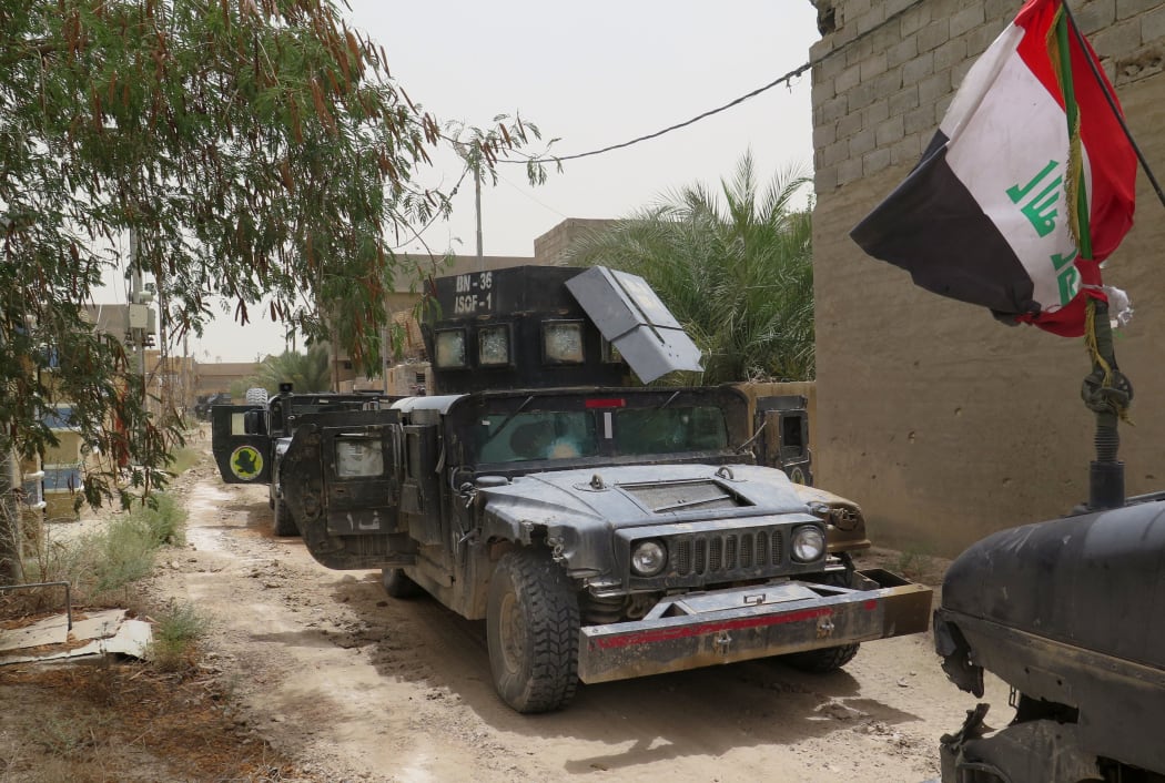 Iraqi counter terrorism force vehicles parked on a street in Fallujah on 16 June 2016.