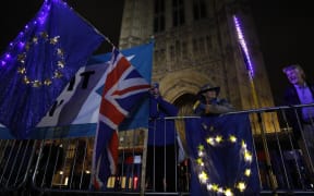 Anti-Brexit protesters with signs and EU flags demonstrate outside the Houses of Parliament in London on September 9.