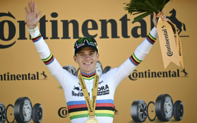 Red Bull-Bora-Hansgrohe team's Remco Evenepoel celebrates on the podium after winning the 16th stage of the 113th edition of the Tour de France cycling race, in the French Alps, on July 21, 2026. (Photo by Loic VENANCE / AFP)