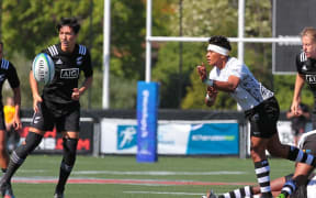 Fiji's Lavenia Tinai moves the ball away from the New Zealand defence.