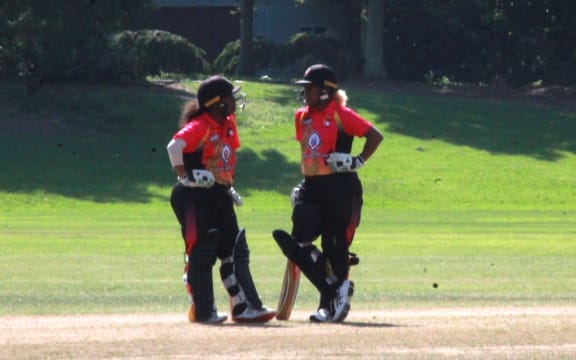 PNG captain Brenda Hoi Tau, left, has a chat with fellow batter Naoani (crrct)Vare.
