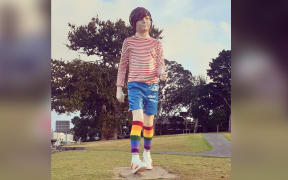 A large statue of a child wearing rainbow socks.