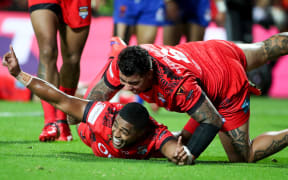 Tonga's Michael Jennings celebrates a try.