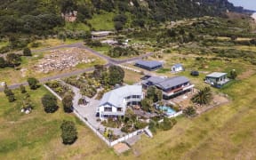 Several homes have already been removed from the Awatarariki fanhead. Rick and Rachel Whalley’s (front) will be the last to go.