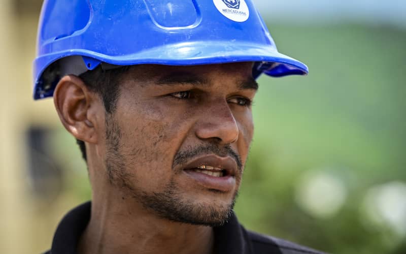 Miguel Baez, a volunteer rescuer, stands outside the collapsed apartment building where his family lived as he and relatives search for family members believed to be trapped inside, in Caraballeda, La Guaira state, Venezuela, on July 12, 2026. The twin earthquakes that struck Venezuela on June 24 had left nearly 4,500 people dead as of July 12, while much of the affected population continued to live in camps, according to official figures. (Photo by MARTIN BERNETTI / AFP)