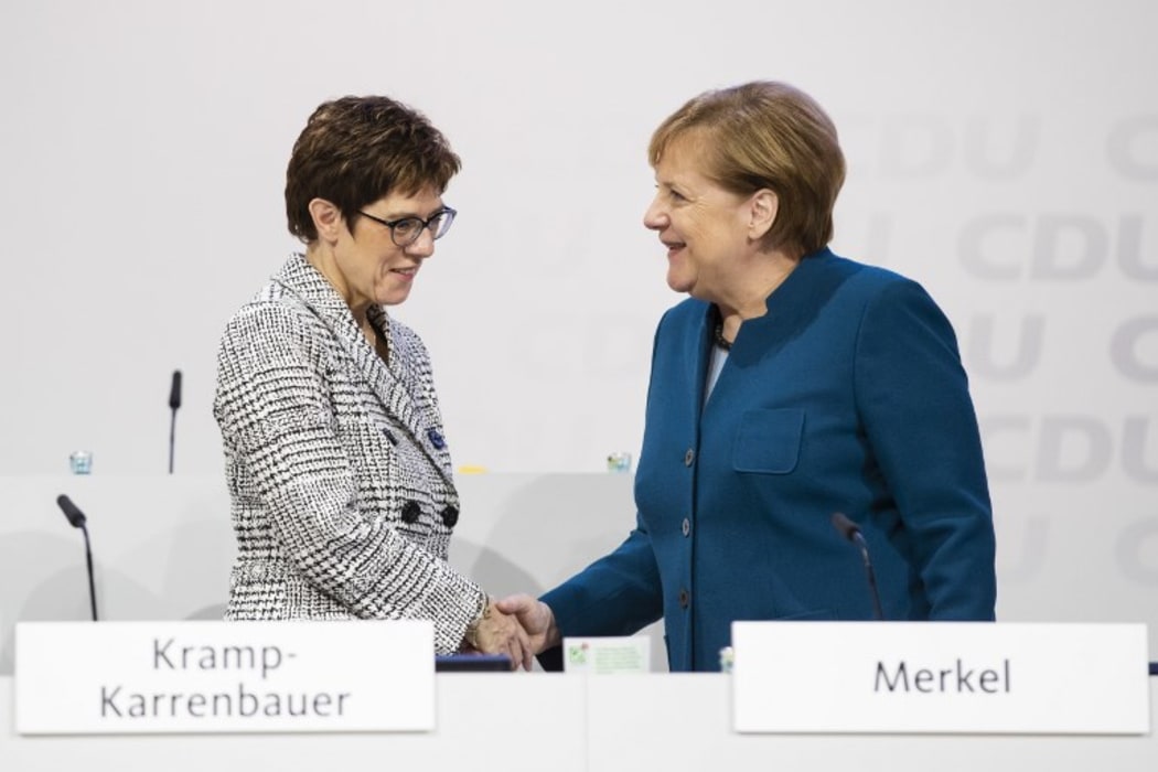 German Chancellor and Chairwoman of the Christian Democratic Union (CDU) Angela Merkel (R)greets CDU Secretary General Annegret Kramp-Karrenbauer (L) during the 31. Party Congress in Hamburg, Germany on December 7, 2018. AFP