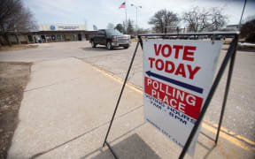 A truck leaves a polling place in Warren, Michigan, today as Michigan residents vote in their presidential primary.