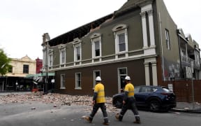Emergency and rescue officials examine damaged buildings in the popular shopping Chapel Street in Melbourne on September 22, 2021, after a 5.8-magnitude earthquake.