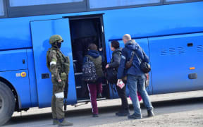 Civilians who were evacuated from the territory of Azovstal steel plant board a bus in Mariupol, Donetsk People's Republic on 6 May 2022.