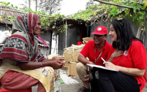 Corinne Ambler of Red Cross talks to  people affected by the floods in Bangladesh.
