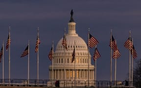 WASHINGTON, DC - DECEMBER 26: The US Capitol Building is seen past the Washington Monument as the sun sets on December 26, 2020 in Washington, DC.