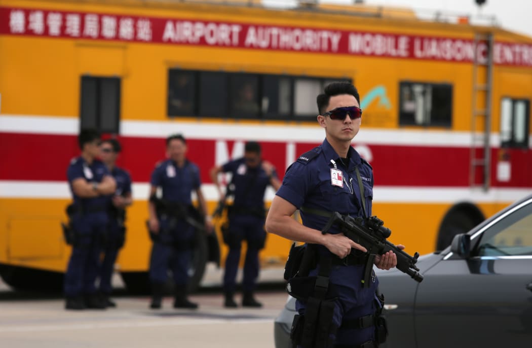 Armed Hong Kong police stand guard before the arrival of China's National People's Congress Standing Committee Chairman Zhang Dejiang.