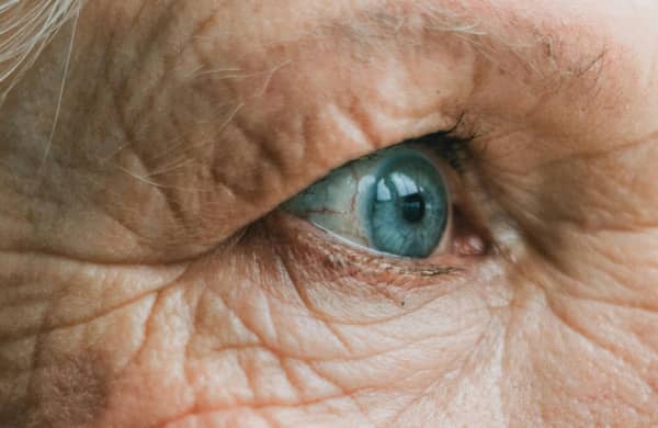 Close up of an elderly woman's blue eye