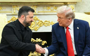 Ukrainian President Volodymyr Zelensky and US President Donald Trump shake hands during a meeting in the Oval Office of the White House in Washington, DC, on August 18, 2025. European leaders join Ukrainian President Volodymyr Zelensky in talks with US President Donald Trump on August 18, as they try to find a way to end Russia's offensive. The leaders heading to Washington on Monday to appear alongside Zelensky call themselves the "coalition of the willing." (Photo by Mandel NGAN / AFP)