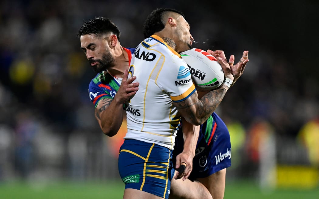 Shaun Johnson of the Warriors tackles Jake Tago of the Parramatta Eels.