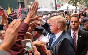 Donald Trump greets supporters outside of Trump Towers in Manhattan October 8, 2016 in New York City.