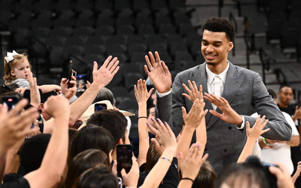 French basketball player Victor Wembanyama, greets the crowd during a news conference introducing the Spurs 2023 Draft Class.