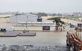 ACE Rentals in Dargaville have been delivering excavators and sweepers through the night to help clear storm damage, but the company's yard flooded with the heavy rain