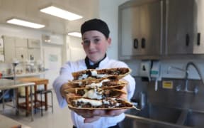 NorthTec Level 4 cookery student Astyn Hobman-Williams with a ‘Tex-Mex wallaby quesadilla with parmesan mayonnaise’ at Northland Field Days, 2025.