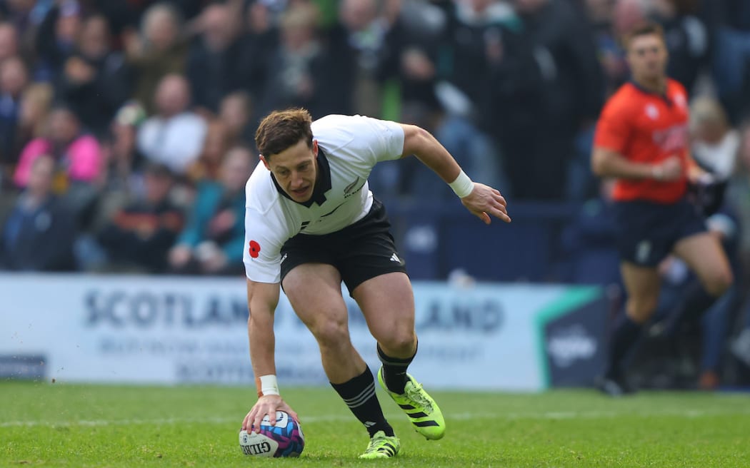 Cam Roigard scores against Scotland.