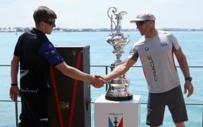Team NZ helmsman Peter Burling, left, and Oracle Team USA's skipper Jimmy Spithill with the America's Cup Trophy, the Auld Mug.