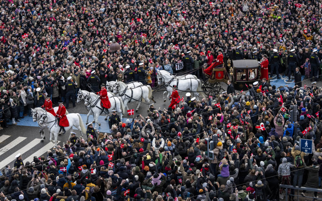 King Frederik X of Denmark and Queen Mary of Denmark make their way past crowds of wellwishers in their carriage carriage during their ride back from Christiansborg Palace to Amalienborg Castle in Copenhagen, Denmark, on January 14, 2024, after the abdication of Denmark's Queen Margrethe II and the proclamation of King Frederik X of Denmark. Denmark turns a page in its history on January 14 when Queen Margrethe abdicates and her son becomes King Frederik X, with more than 100,000 Danes expected to turn out for the unprecedented event. (Photo by Ida Marie Odgaard / Ritzau Scanpix / AFP) / Denmark OUT