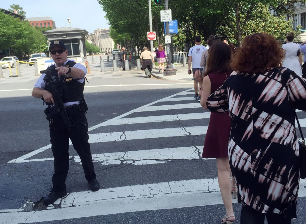 A member of the Secret Service directs people near the Eisenhower Executive Office Building on May 20, 2016 in Washington,DC.