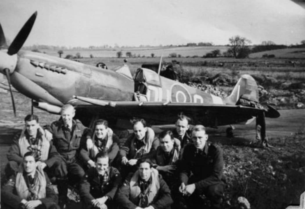 A group of No 485 Squadron pilots in front of one of their aircraft at RAF Station Selsey, at the dawn of D Day.