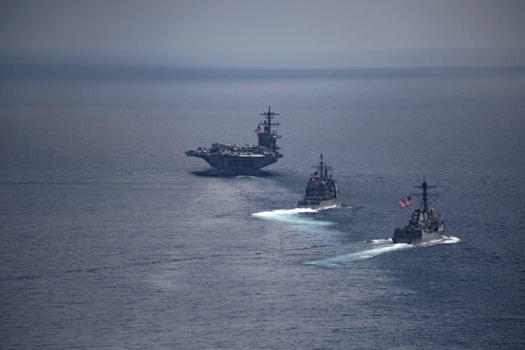 The aircraft carrier USS Carl Vinson (L) leading the Arleigh Burke-class guided-missile destroyer USS Michael Murphy in South Korean waters.